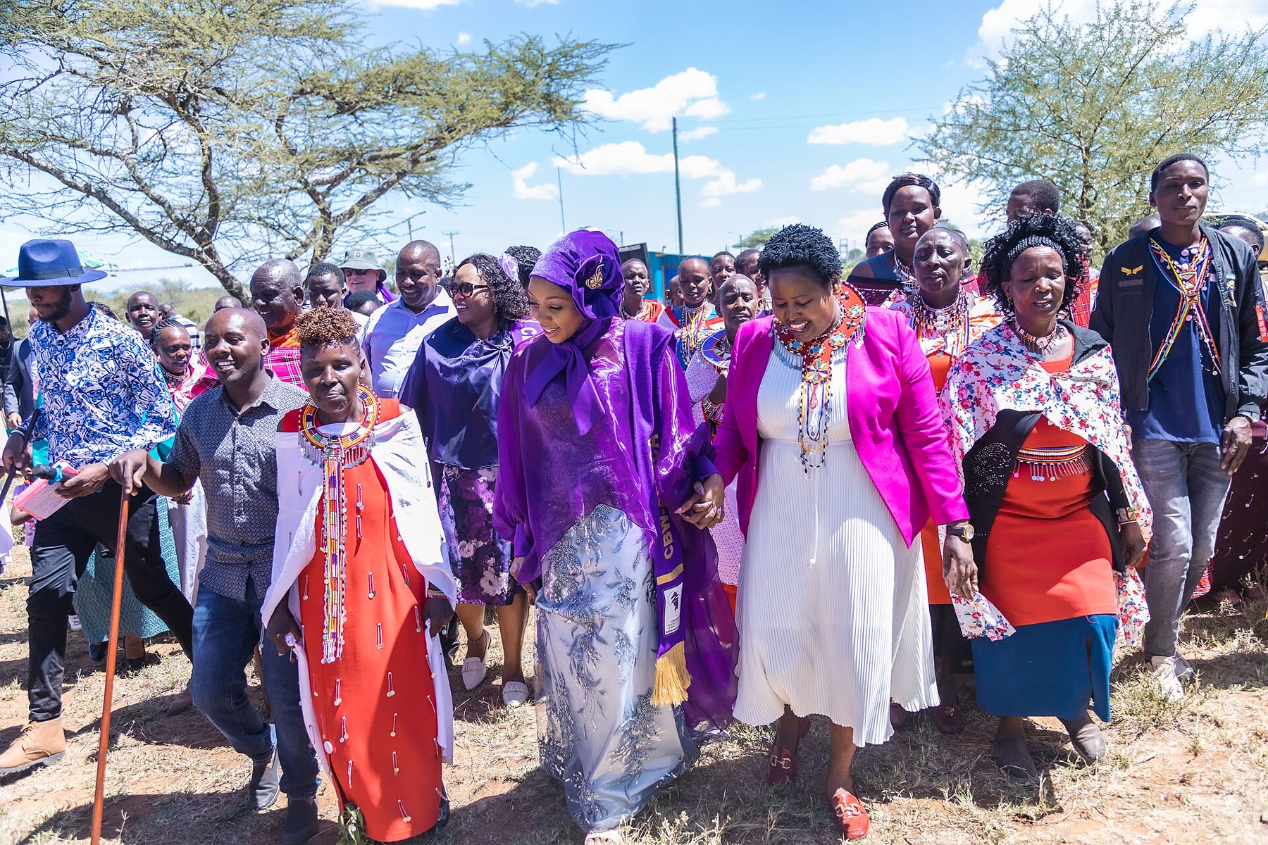 Women walking together to a community gathering